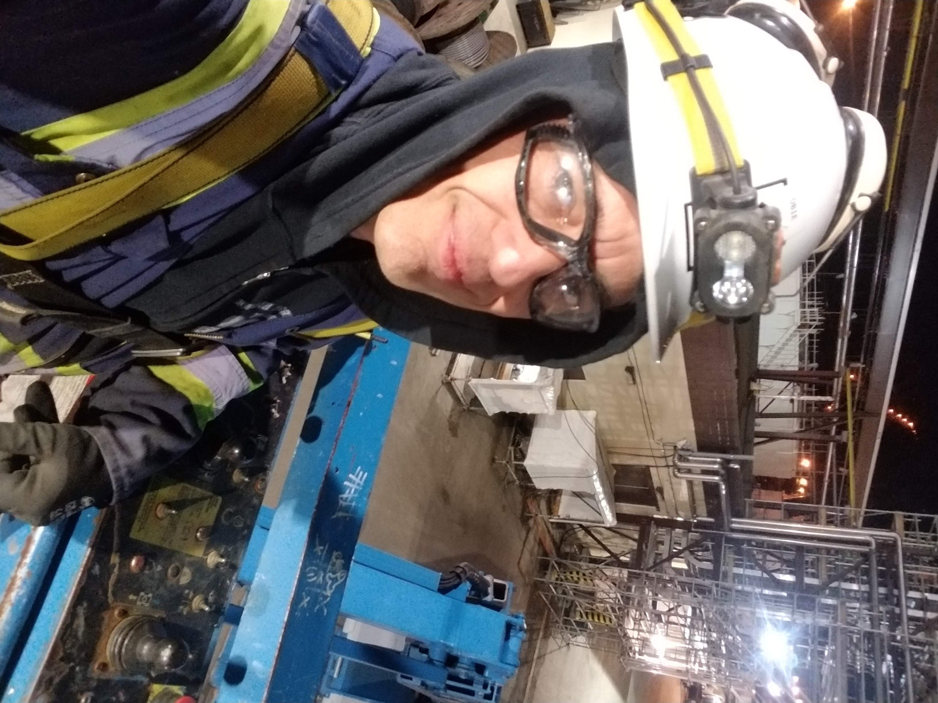 Obadiah Creek in safety gear beside blue industrial equipment at Teck Acid Plant No. 2 in 2018.